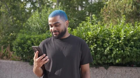 Young african american student using a smartphone looking at screen 스톡 동영상 285660969