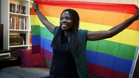 Young african american woman with lgbtq pride flag. Stock Footage