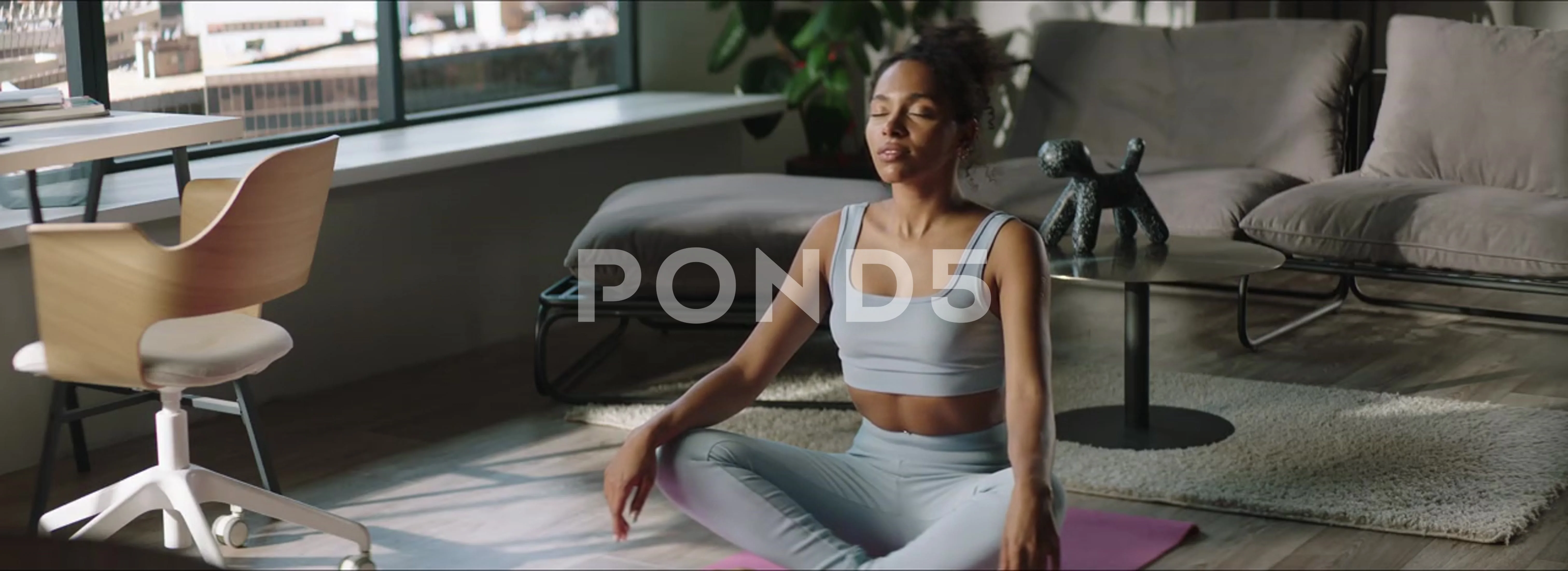 Young African American woman practicing yoga positions at home