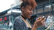 Young African American Woman Using Mobile Phone In The Urban Street Stock Footage