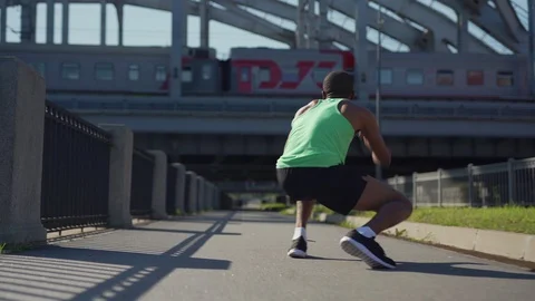 Young African athlete practicing duck walk Stock Footage 117063601