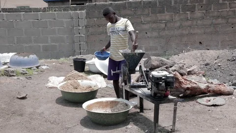 Young African boy using a local grinding mill Stock Footage 105101630