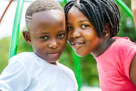 Young African brother and sister joining heads outdoors. Stock Photos
