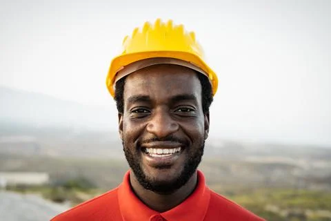 Young African builder working on construction site Stock Photos