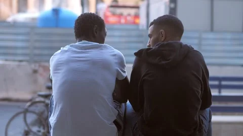 Young african confides his problems to his friend who comforts him Stock Footage 240326071