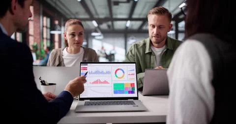 Young African Data Analyst Leads Business Meeting With Computer Dashboard Stock Photos