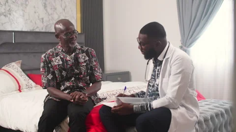 Young African Doctor Having Conversation with Senior Patient in Elder Care Video stock 346007332