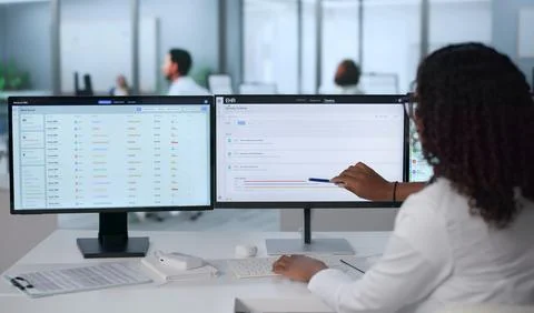 Young African Doctor Using Computer To Update Patient Health Records Efficien Stock Photos