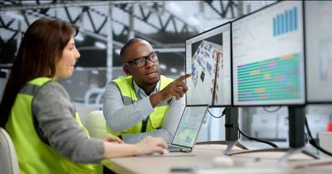 Young African Engineer Uses 3D Software On A Desktop To Optimize Factory Layo Stock Photos