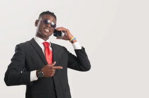 Young african guy looking at cell phone Stock Photos