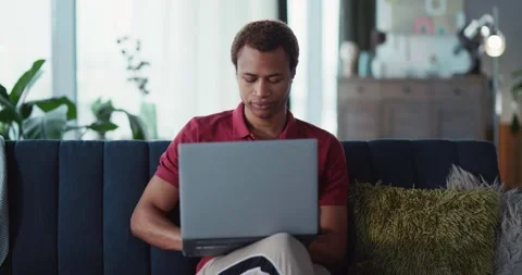 Young african handsome man doing freelance online project on laptop computer Stock Footage 148160792