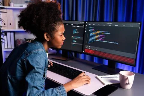 Young African IT developer checking code, concentrate on screen. Tastemaker. Stock Photos