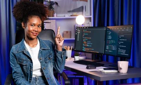 Young African IT developer presenting program and focus on camera. Tastemaker. Foto stock