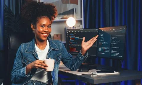 Young African IT developer presenting program and focus on camera. Tastemaker. Foto stock