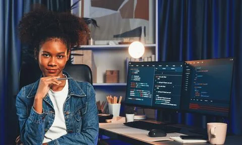 Young African IT developer presenting program and focus on camera. Tastemaker. Foto stock