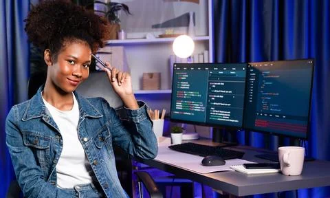 Young African IT developer presenting program and focus on camera. Tastemaker. Stockfoto's