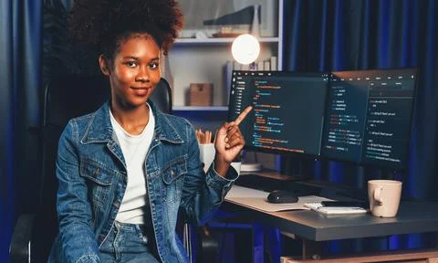 Young African IT developer presenting program and focus on camera. Tastemaker. Stockfoto's