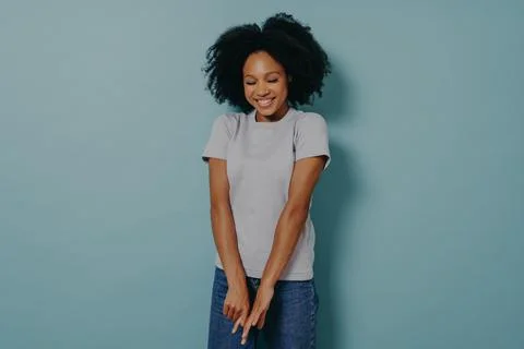 Young african lady looking down with with shy timid face expression, isolated Foto stock