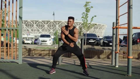 Young african man doing warm up exercises before workout Stock Footage 140799537