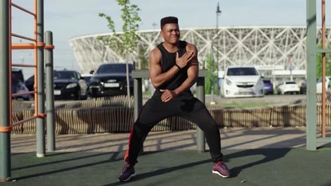 Young african man doing warm up exercises before workout Stock-Footage 143500784