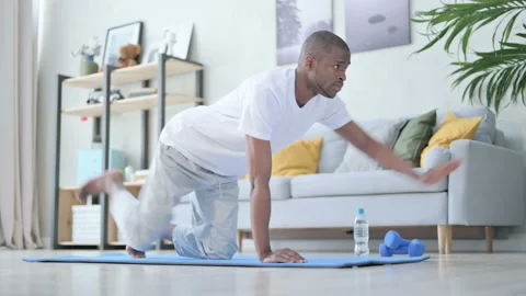 Young African Man doing Workout on Yoga Mat at Home Video stock 154721550