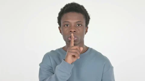Young African Man with Finger on Lips, Silence on White Background Stock Footage 222765645