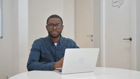 Young African Man Looking at Camera in Office Stock Footage 309508049