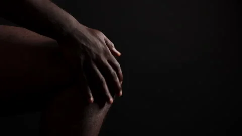 Young African Man suffering from knee pain. Video stock 345835757