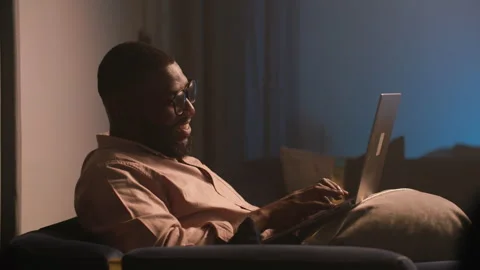 Young African Man Using Laptop at Home for Social Media and Email 動画素材 346007546