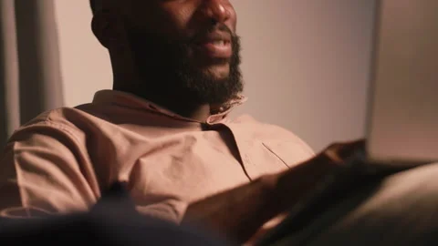 Young African Man Using Laptop at Home for Video Call and Email Video stock 346007624