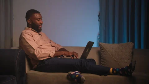 Young African Man Using Laptop for Video Call and Social Media at Home Video stock 346007654