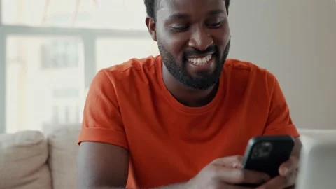 Young African man using smart phone while spending time at home Stock Footage 155541572