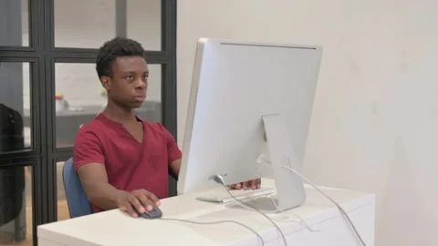 Young African Man Working on Desktop Computer Stock Footage 303209866
