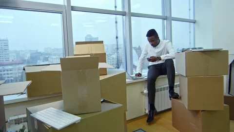 Young African Manager Working on Window Sill after Moving in Office Vídeos de archivo 88697768