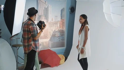 Young african model posing on bar high chair during photoshoot Stock Footage 122577958