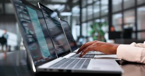 Young African Software Engineer Coding Secure Data On Laptop At Busy Office. Stock Photos