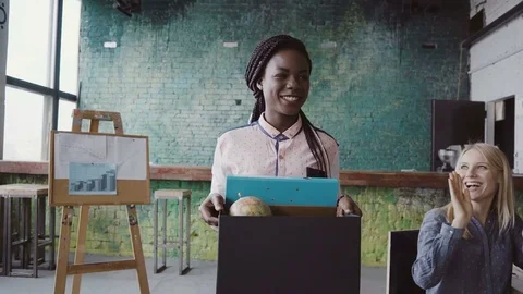 Young african woman recently hired for corporate job comes into new office Stock Footage
