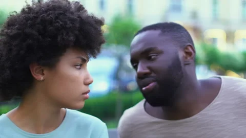 Young afro-american couple arguing outdoors, lies in relationships, breakup Stock Footage