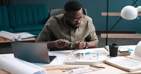 Young afro-American Designer are choosing Colors for hes project. Two Architects Video stock 147861353