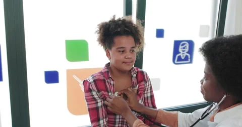 Young Afro-american Doctor Checking Patient. Practitioner Checking Heartbeat of Video stock 146612922
