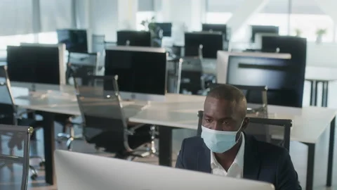 Young Afro-American Man in Protective Face Mask Surfing the Internet on Laptop Stock Footage 194006700