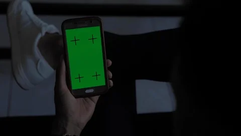 Young afro american man using his smartphone mock-up green screen in his living Video stock 110772185