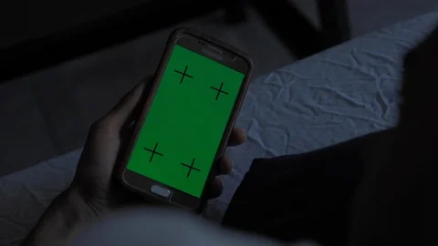 Young afro american man using his smartphone mock-up green screen in his room at Stock-Footage 110772248