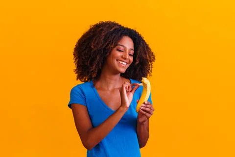 Young afro girl eating banana. Health concept. Healthy eating Stock Photos