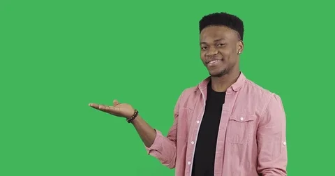Young afro guy in the shirt raises her hand and shows something. Stock Footage 83891560