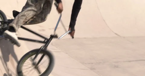 Young afro man jumping with a trial bike in a skatepark. BMX bike. Urban life Stock Footage 151484457