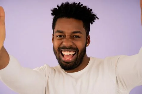 Young afro man looking at camera and taking a selfie. Stock Photos