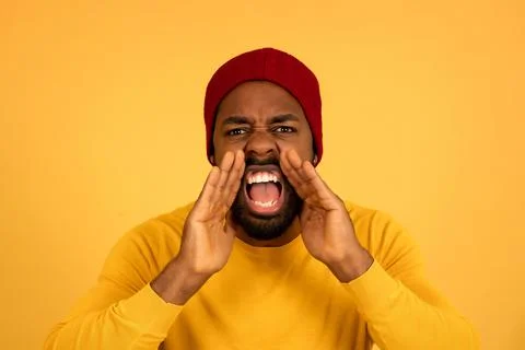 Young afro man screaming to the camera. Stock Photos