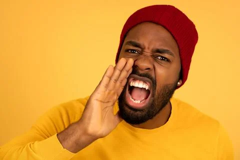 Young afro man screaming to the camera. Stock Photos