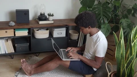 Young afro man working at home with a laptop. Stock Footage 161316273
